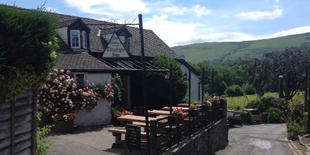 Outside the Triangle Inn looking down to the River Wye with the rolling foothills of the Cambrian Mountains in the background